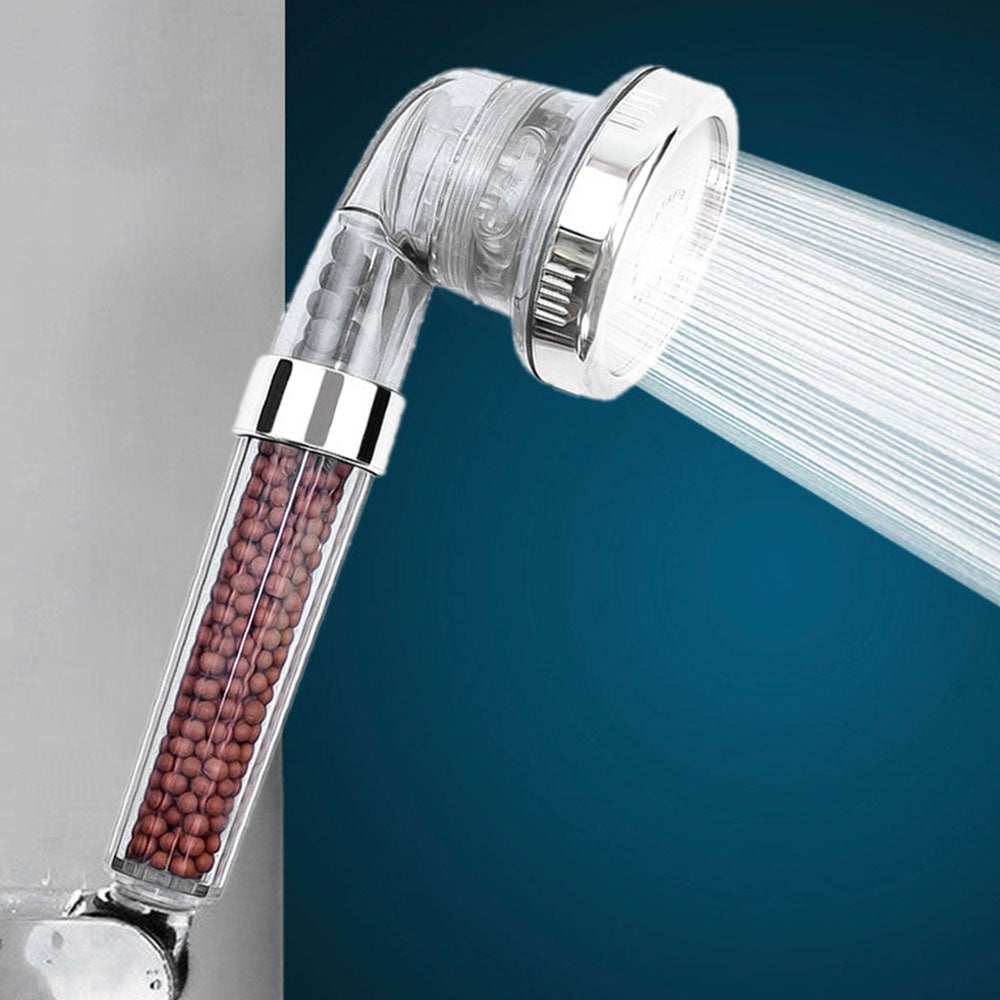 3 mode shower head with built in water purifier filter with clear plastic housing and water flowing against a blue background