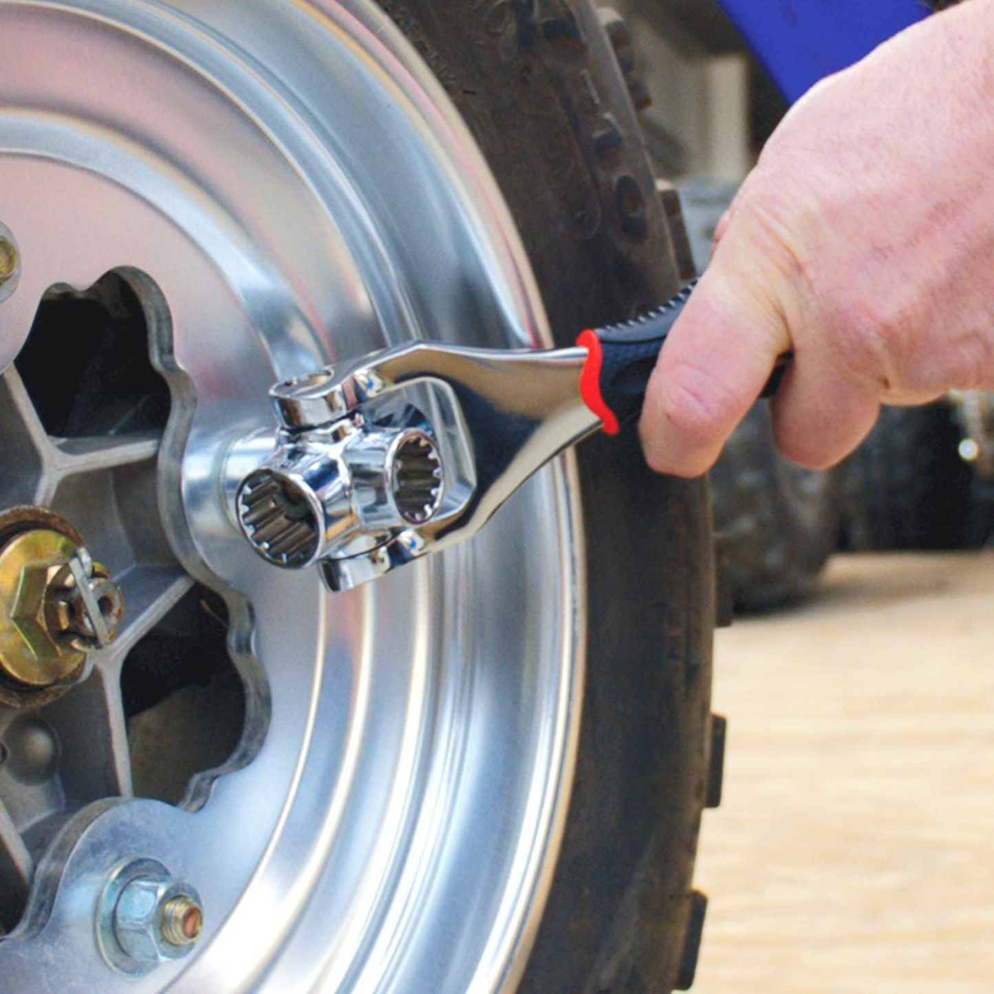 Person using the 48-in-1 Universal Socket Wrench on a car wheel