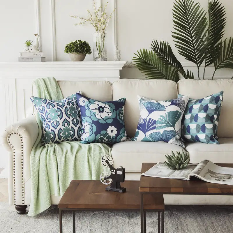 Living room with a beige sofa adorned with Set of four blue geometric pattern cushion covers in Nordic style, on a sofa and living room decor, a wooden coffee table, and decorative items.