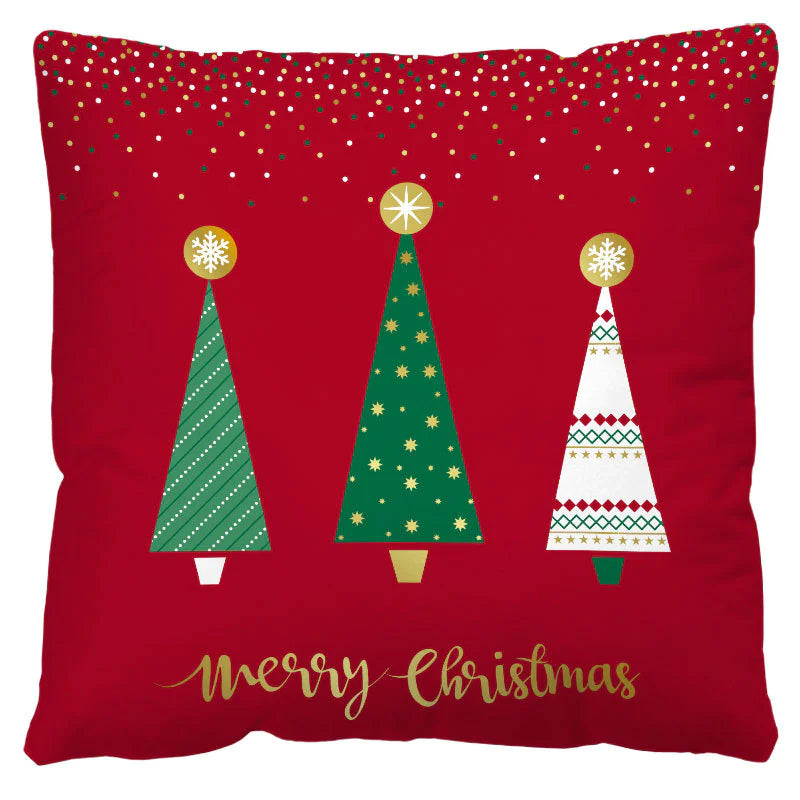 Decorative pillow with Christmas trees and 'Merry Christmas' text on a red background