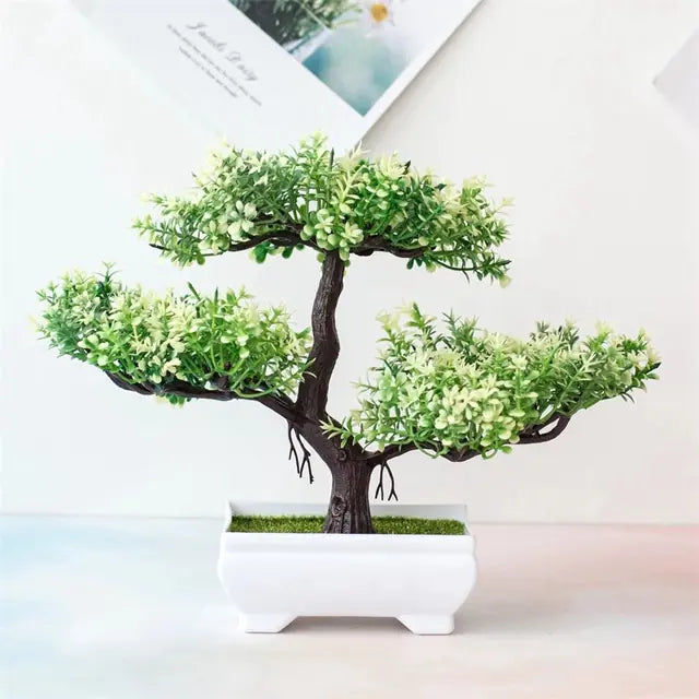 Artificial bonsai tree in a pot on a white background