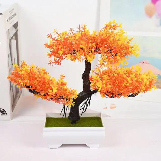 Artificial bonsai tree with orange leaves in a white pot on a light background