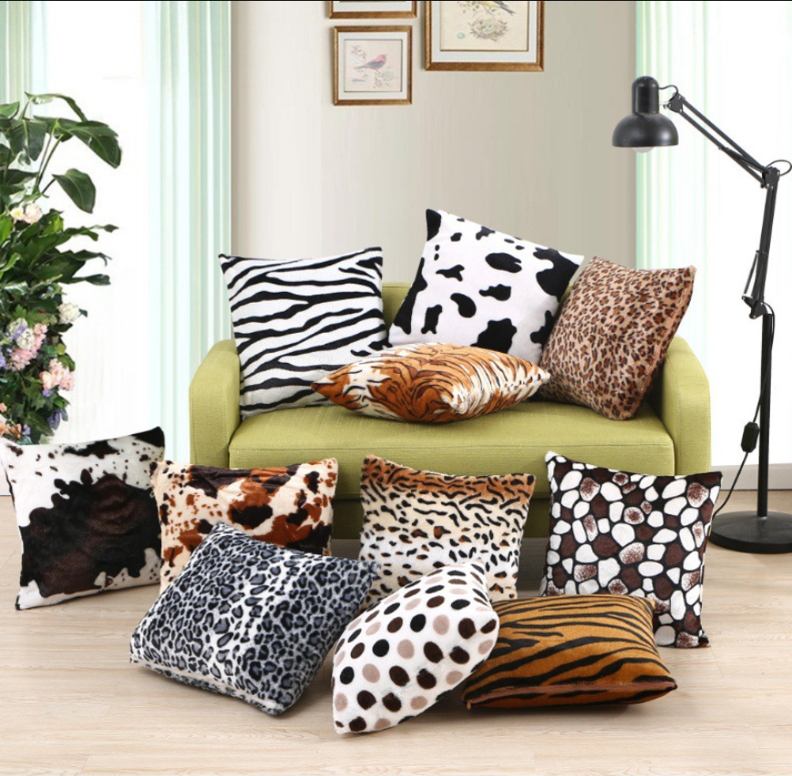 Assorted animal print faux fur throw pillow cover in luxurious plush material, 43cm x 43cm, decorative cushion cover for sofa and bedroom decor on a green sofa in a living room setting.