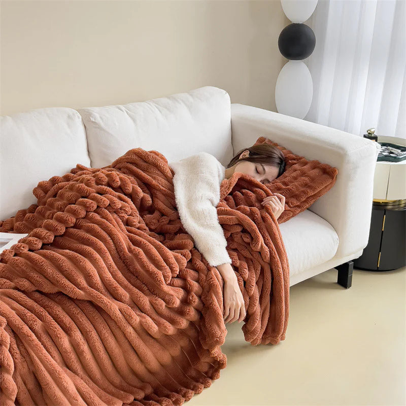 Brown cosy ribbed fleece throw blanket in neutral colour draped over couch, soft textured warm blanket for home comfort and relaxation.