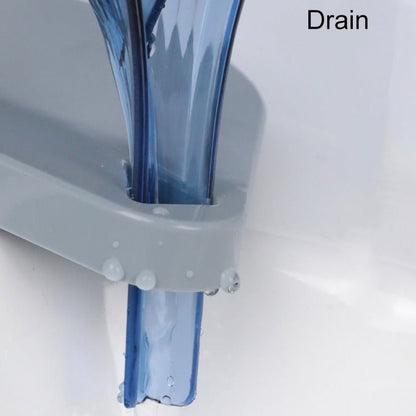 Close up of a drain with clear water flowing through it on a white background.