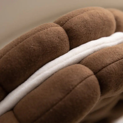 Close up of biscuit shaped plush cushion chocolate coffee plush cushions with a white stripe.