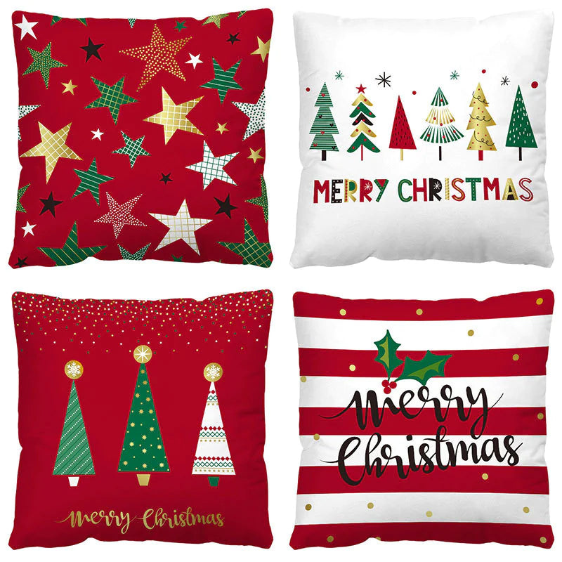 Four Christmas themed pillows with festive designs on a white background.