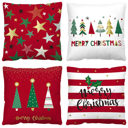 Four Christmas themed pillows with festive designs on a white background.