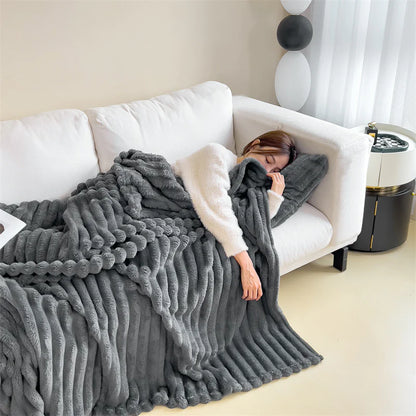 Dark Grey cosy ribbed fleece throw blanket in neutral colour draped over couch, soft textured warm blanket for home comfort and relaxation.