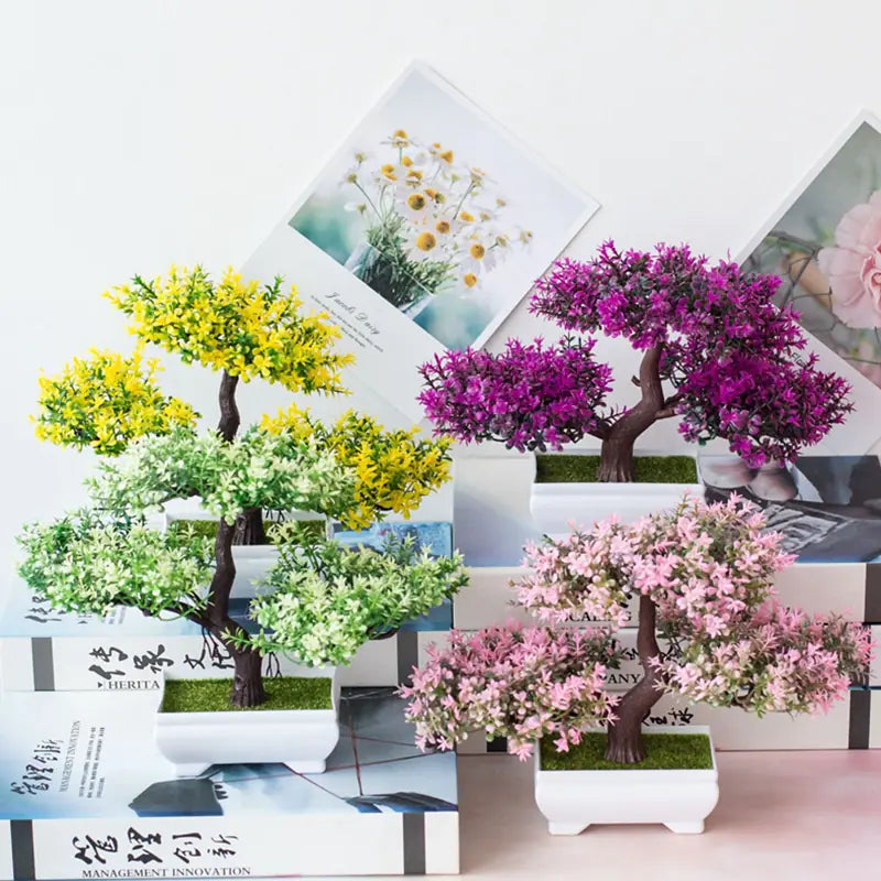 Decorative artificial bonsai trees in pots on a white background