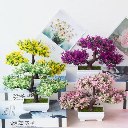 Decorative artificial bonsai trees in pots on a white background