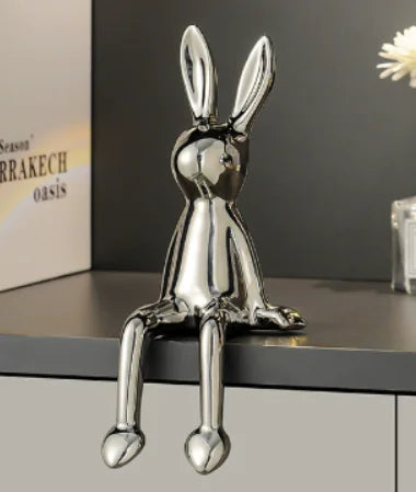 Electroplated metallic rabbit figurine with shiny finish for modern home decor, as decorative ornament on a shelf with a dark background