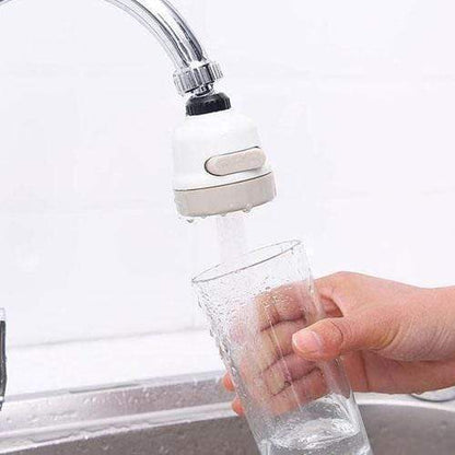 Faucet with a water filter attachment being used to fill a glass.