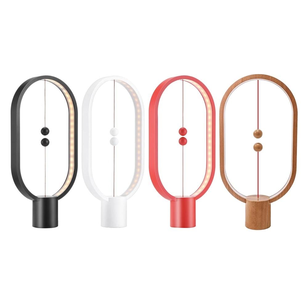 Four different colours of Modern LED magnetic table lamp with suspended magnetic sphere switch on a white background