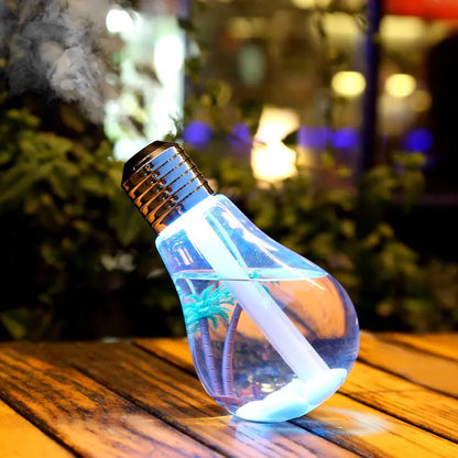 LED humidifier lamp with bulb design in gold finish displaying colourful ambient lighting on modern home decor table