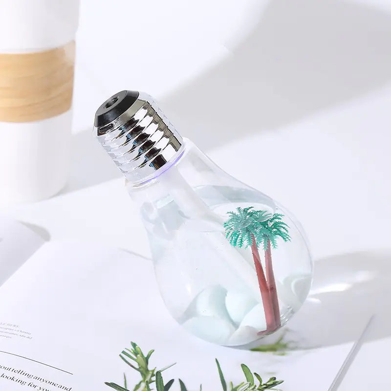 Light bulb shaped bottle with palm tree design on a white background