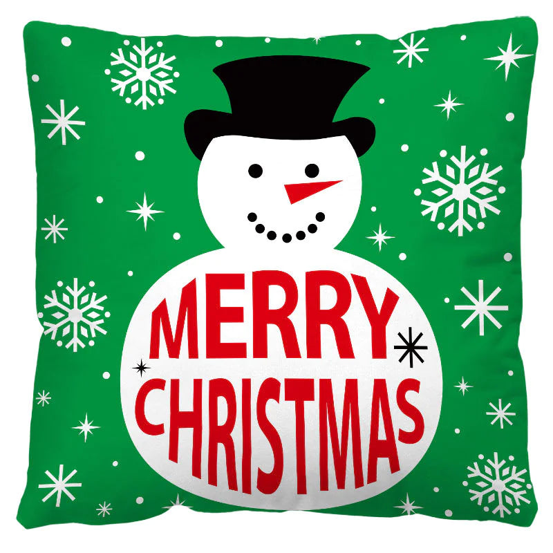 Christmas themed pillow with a snowman and 'Merry Christmas' text on a green background with snowflakes.