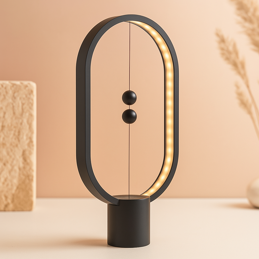Modern black LED magnetic table lamp with suspended magnetic sphere switch creating ambient warm lighting on a beige background