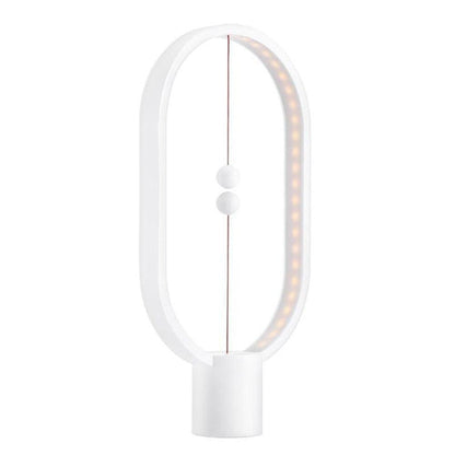 Modern white LED magnetic table lamp with suspended magnetic sphere switch creating ambient warm lighting on a white background