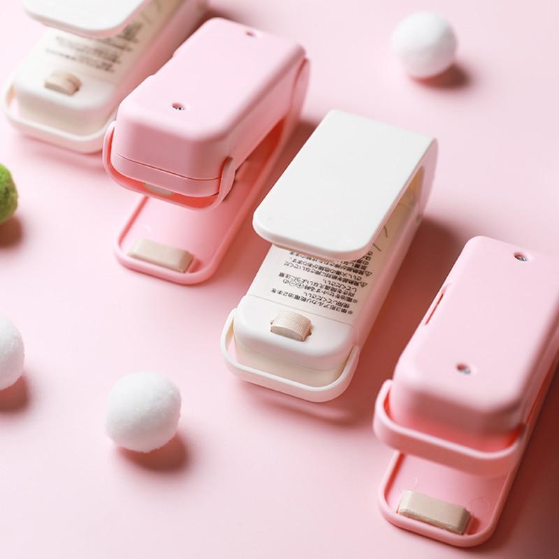 Pink and white Mini heat bag sealers device on a pink background