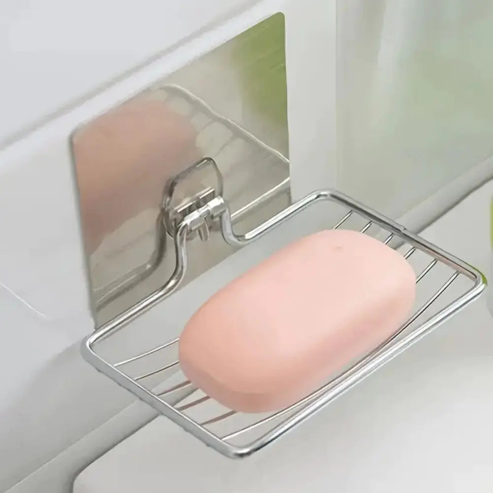 Pink bar of soap on a Stainless steel wall mounted soap dish holder with self adhesive backing attached to a tiled wall.