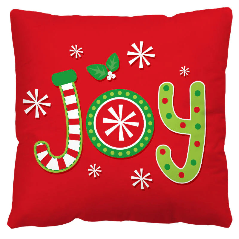 Red pillow with 'JOY' text in festive letters on a white background
