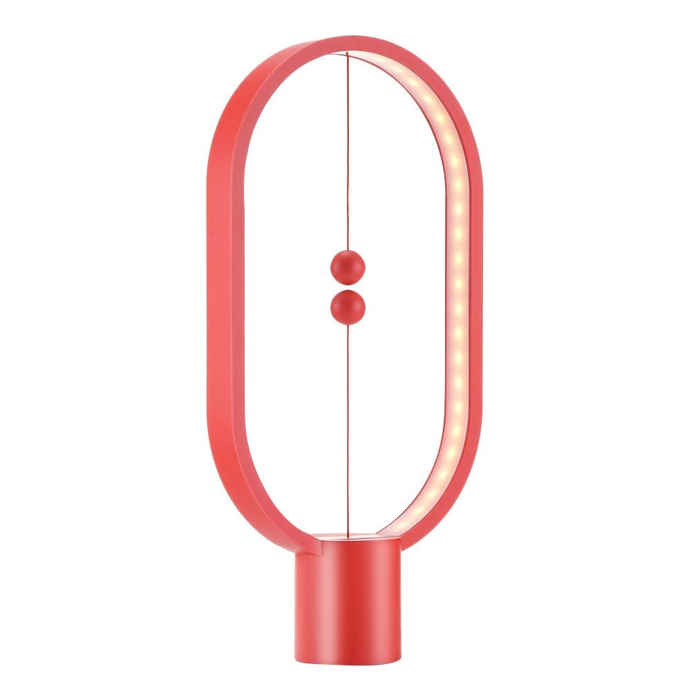 Red Modern LED magnetic table lamp with suspended magnetic sphere switch creating ambient warm lighting on a white background
