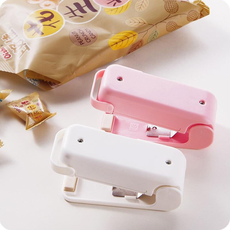 Two colourful Mini heat bag sealer device on a light background with a package of snacks.