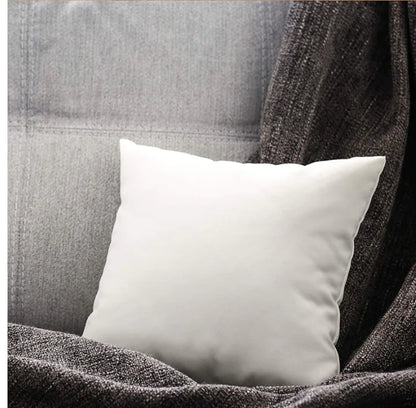 Ultra soft white cushion insert with high elastic PP cotton filling and brushed fabric cover for superior comfort and support on a grey couch with a grey blanket